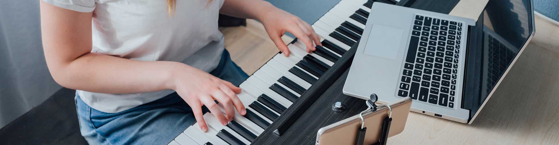 Teenager leaning piano